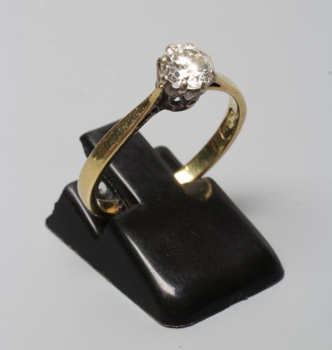 A DIAMOND SOLITAIRE RING, the old brilliant cut stone of approximately 0.60cts, claw set to a plain Image