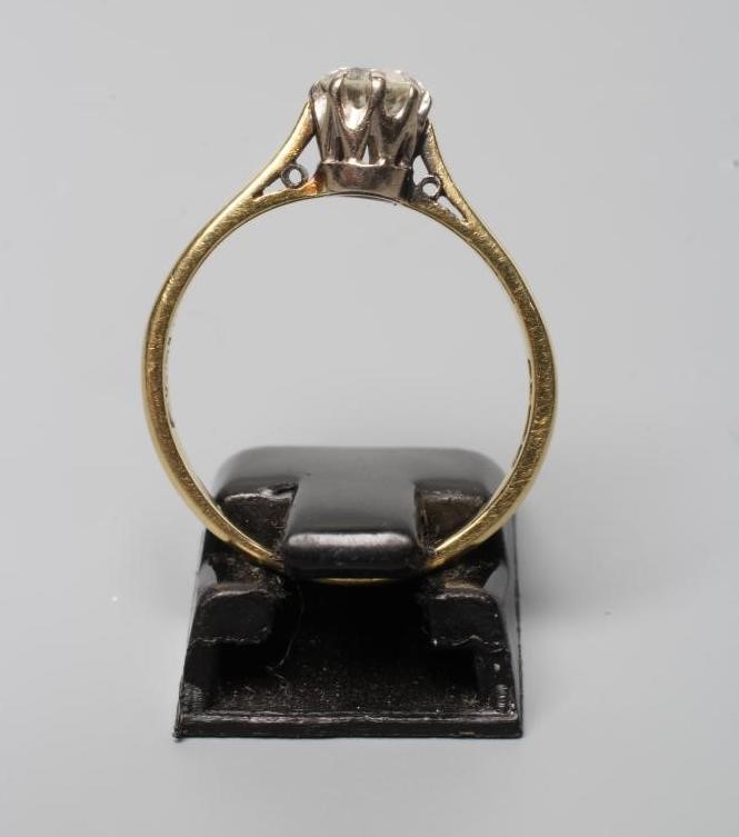 A DIAMOND SOLITAIRE RING, the old brilliant cut stone of approximately 0.60cts, claw set to a plain Image