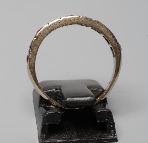 A RUBY AND DIAMOND HALF HOOP RING, the five rubies and four small diamonds point set to a plain Image