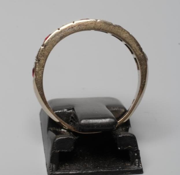 A RUBY AND DIAMOND HALF HOOP RING, the five rubies and four small diamonds point set to a plain Image