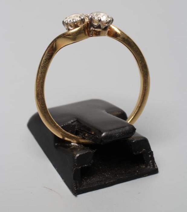 A TWO STONE DIAMOND CROSSOVER RING, the brilliant cut stones each of approximately 0.25 cts, claw Image