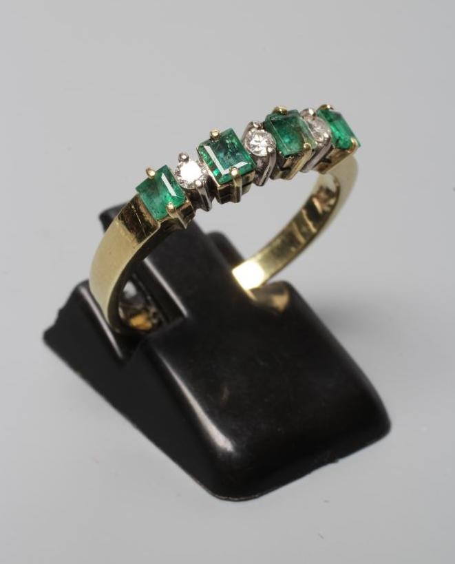 A SEVEN STONE EMERALD AND DIAMOND HALF HOOP RING Image