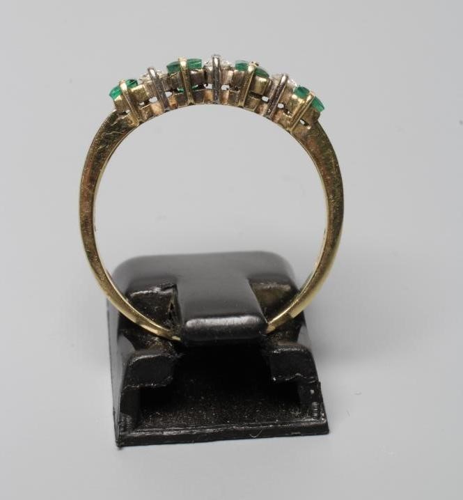 A SEVEN STONE EMERALD AND DIAMOND HALF HOOP RING Image
