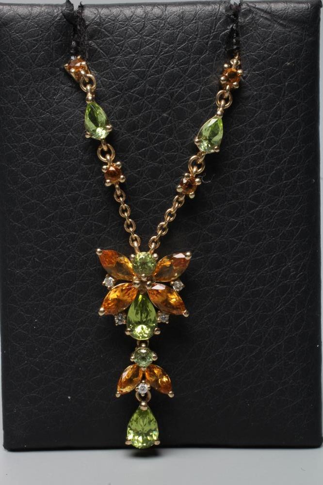 A CITRINE, PERIDOT AND AND DIAMOND FLOWER DROP PENDANT, fixed to a fine chain with two citrine and a Image
