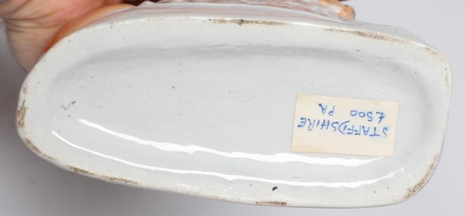 A PAIR OF VICTORIAN STAFFORDSHIRE POTTERY VAN AMBURGH LION AND LAMB FLATBACK MODELS, well moulded Image