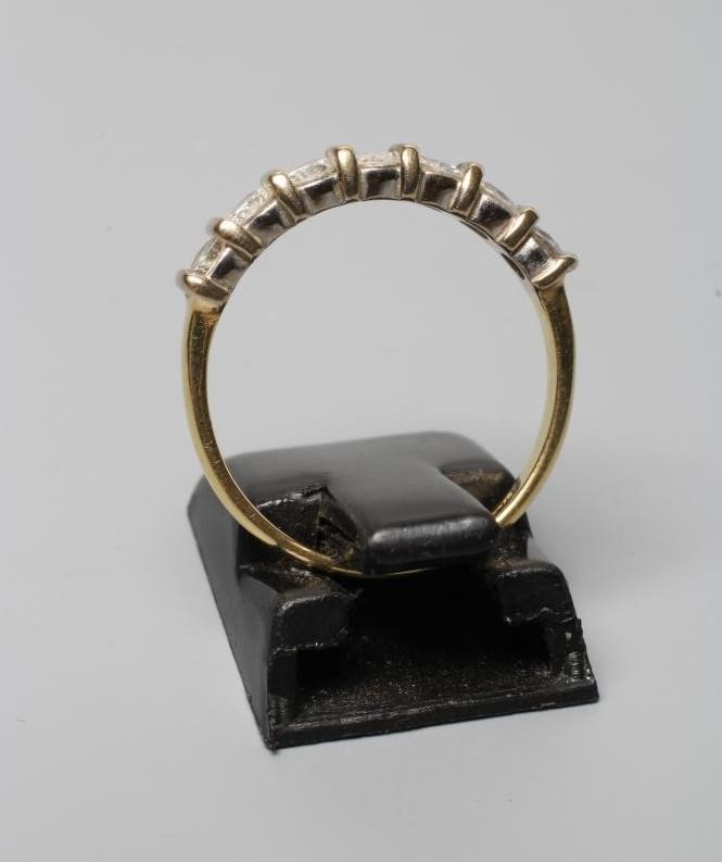 A SEVEN STONE DIAMOND HALF HOOP ETERNITY RING, the round brilliant cut stones line set to a plain Image