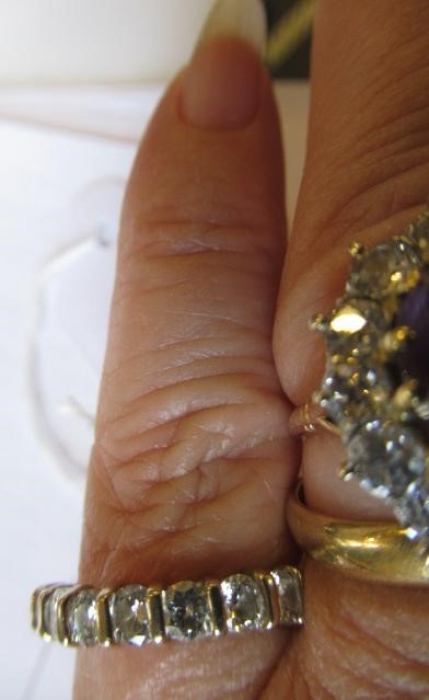 A SEVEN STONE DIAMOND HALF HOOP ETERNITY RING, the round brilliant cut stones line set to a plain Image