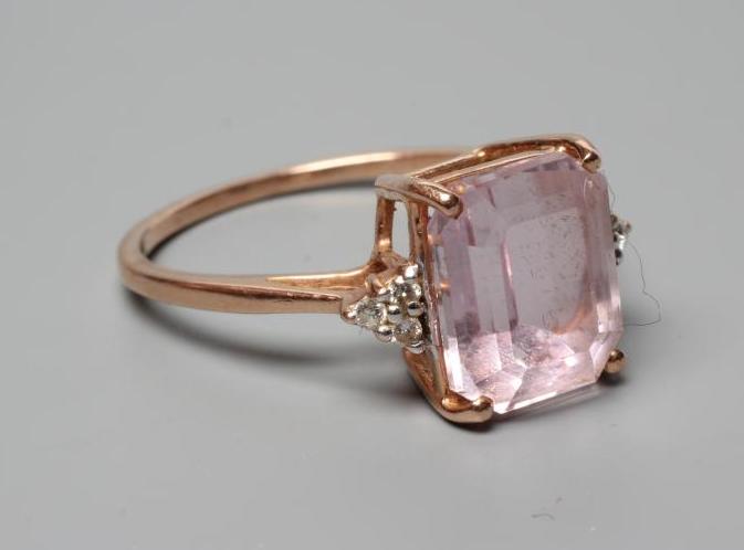 A KUNZITE AND DIAMOND DRESS RING, the oblong cut Kunzite claw set and with three small round Image