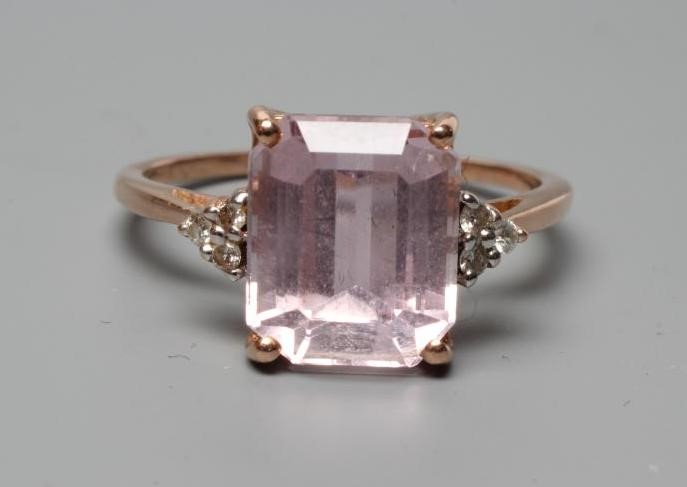 A KUNZITE AND DIAMOND DRESS RING, the oblong cut Kunzite claw set and with three small round Image
