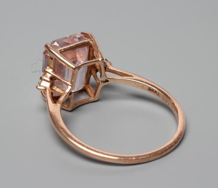 A KUNZITE AND DIAMOND DRESS RING, the oblong cut Kunzite claw set and with three small round Image