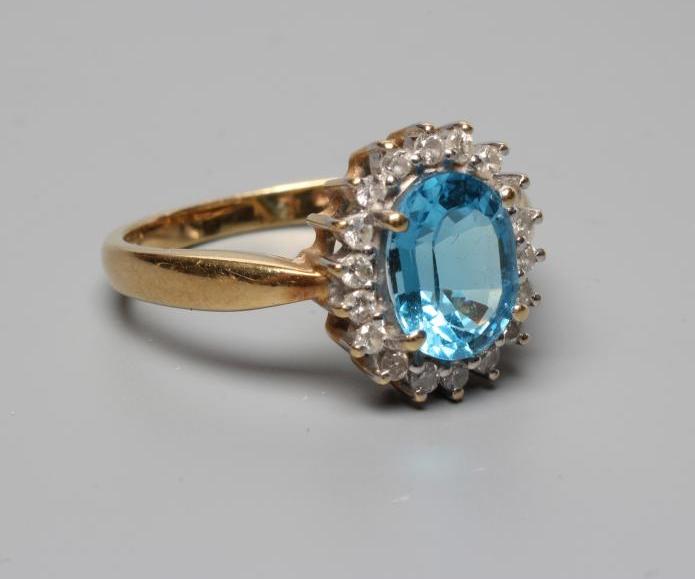 A BLUE TOPAZ AND DIAMOND CLUSTER RING Image