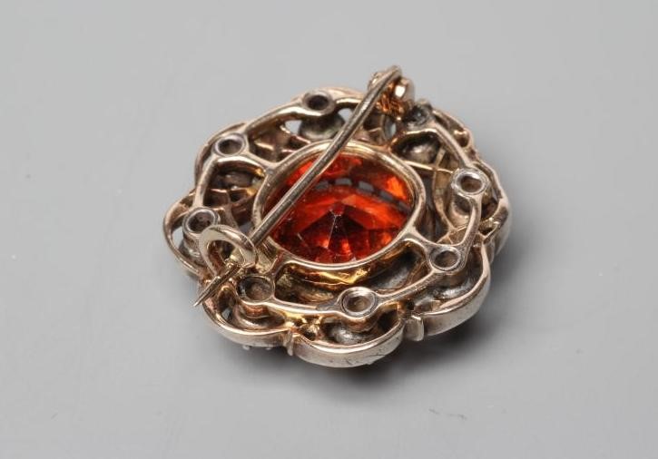 A LATE VICTORIAN HESSONITE GARNET AND DIAMOND BROOCH Image