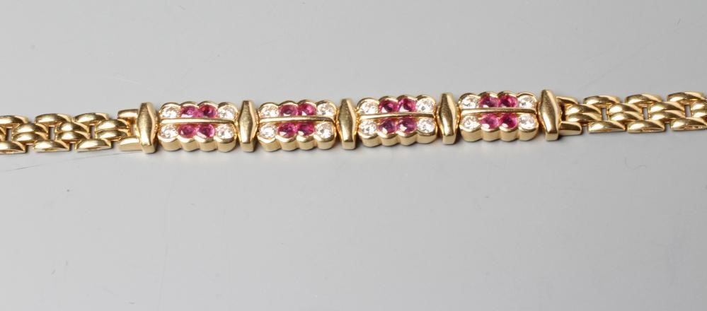 A RUBY AND DIAMOND BRACELET, the 18ct gold brick links centred by four panels each channel set with Image