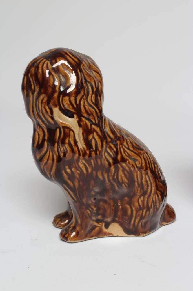 A PAIR OF EARLY VICTORIAN TREACLE GLAZED HEAVY STONEWARE SPANIELS modelled with a free standing fore Image