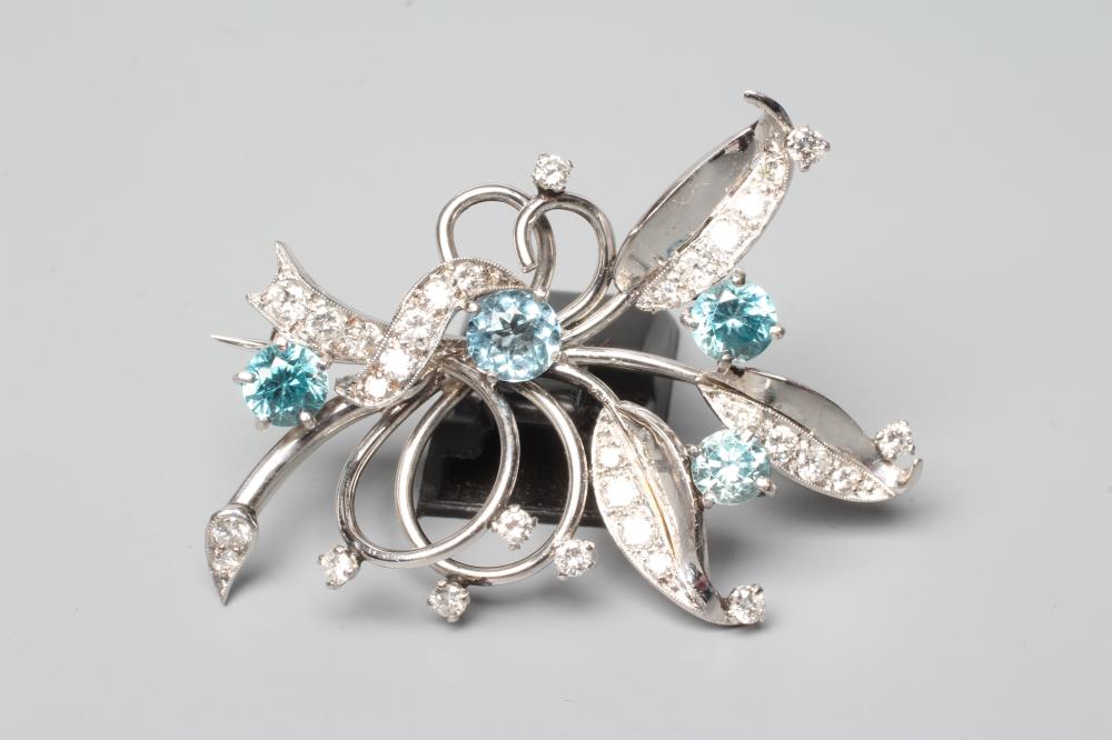 A BLUE ZIRCON AND DIAMOND SPRAY BROOCH of open wirework form claw set with four facet cut zircons Image