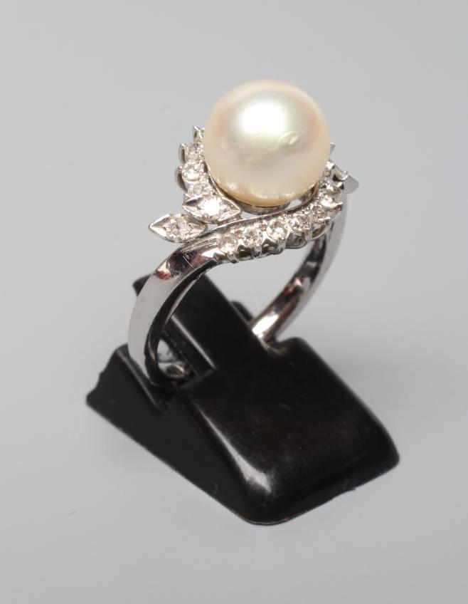 A PEARL AND DIAMOND COCKTAIL RING, the cultured pearl set to a swirl border of small diamonds to a Image