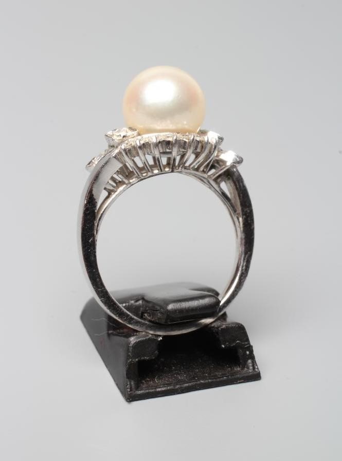 A PEARL AND DIAMOND COCKTAIL RING, the cultured pearl set to a swirl border of small diamonds to a Image