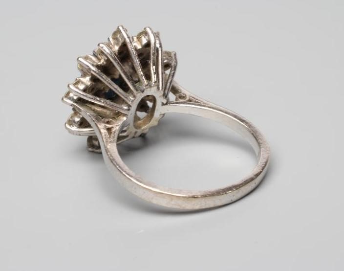 A SAPPHIRE AND DIAMOND CLUSTER RING Image