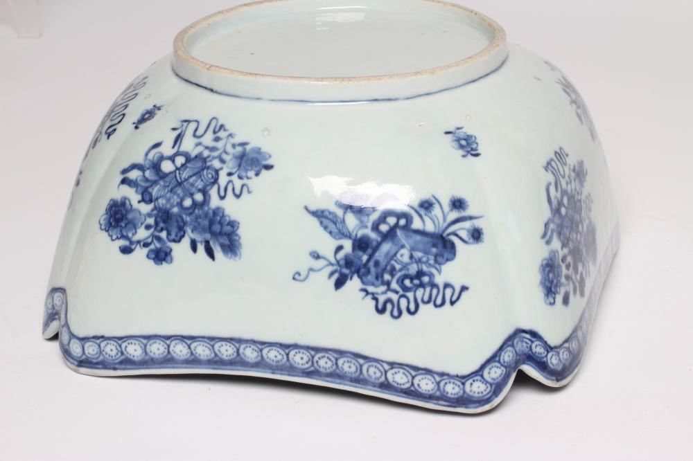 A CHINESE PORCELAIN BOWL of lobed square form painted in underglaze blue with precious objects below Image