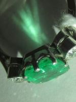 AN EMERALD AND DIAMOND THREE STONE RING Image