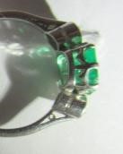 AN EMERALD AND DIAMOND THREE STONE RING Image