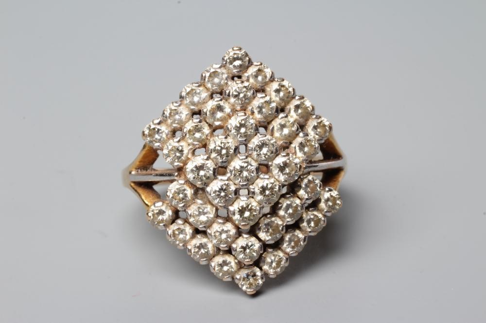 A MODERN GEOMETRIC PANEL DIAMOND CLUSTER RING, the lozenge panels claw set to a plain unmarked Image