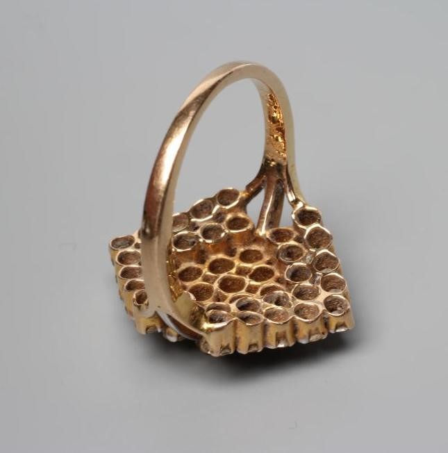 A MODERN GEOMETRIC PANEL DIAMOND CLUSTER RING, the lozenge panels claw set to a plain unmarked Image