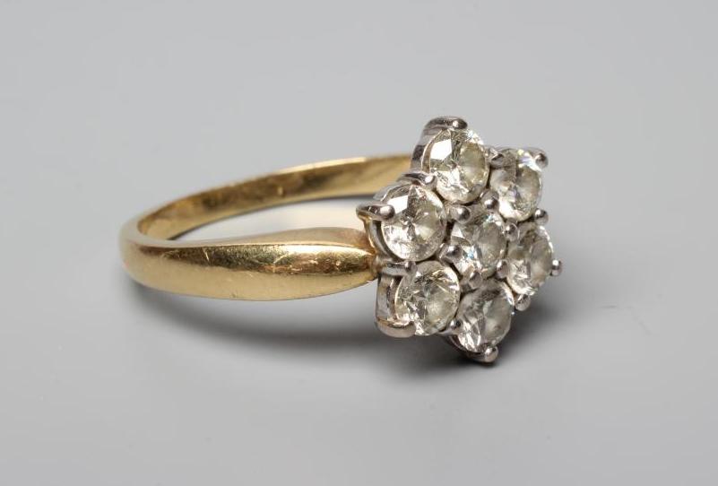 A SEVEN STONE DIAMOND CLUSTER RING, the round brilliant cut stones all of approximately 0.25cts, Image