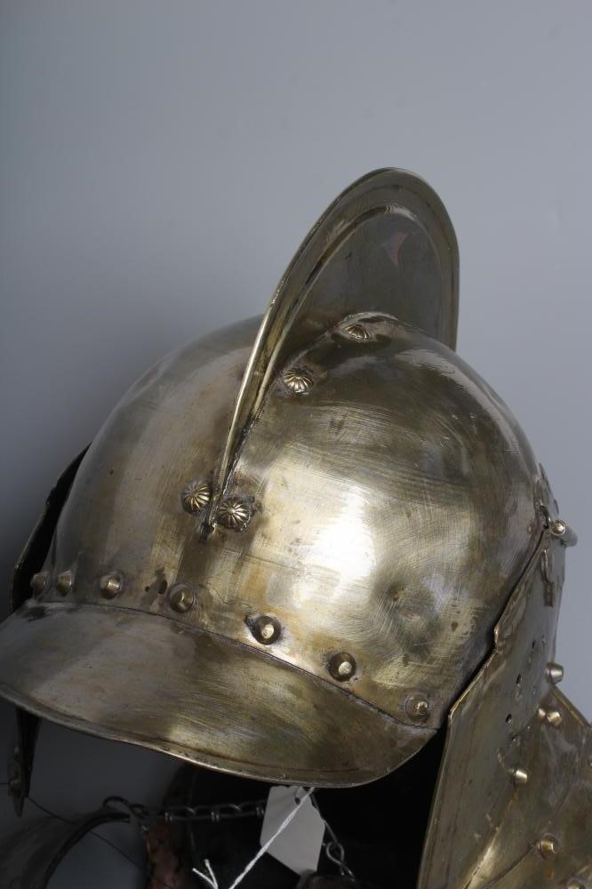A REPRODUCTION BURGONET HELMET with high medial ridge, rounded peak, neck and ear guards, together Image