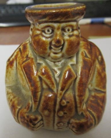 A VICTORIAN STONEWARE NOVELTY INKWELL modelled as Mr Pickwick with a quill hole to each shoulder Image