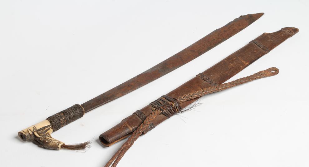 A DAYAK HEAD-HUNTER'S SWORD, the 21" blade shaped and decorated at the tip, carved bone handle, Image