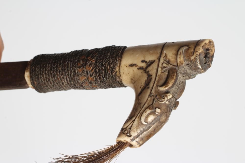 A DAYAK HEAD-HUNTER'S SWORD, the 21" blade shaped and decorated at the tip, carved bone handle, Image