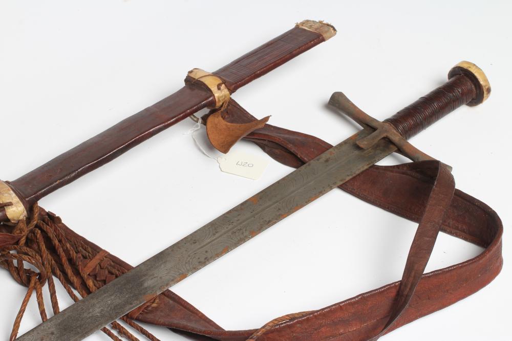A SUDANESE KASKARA SWORD, the 34 1/2" blade etched with script and repeating designs, cruciform Image