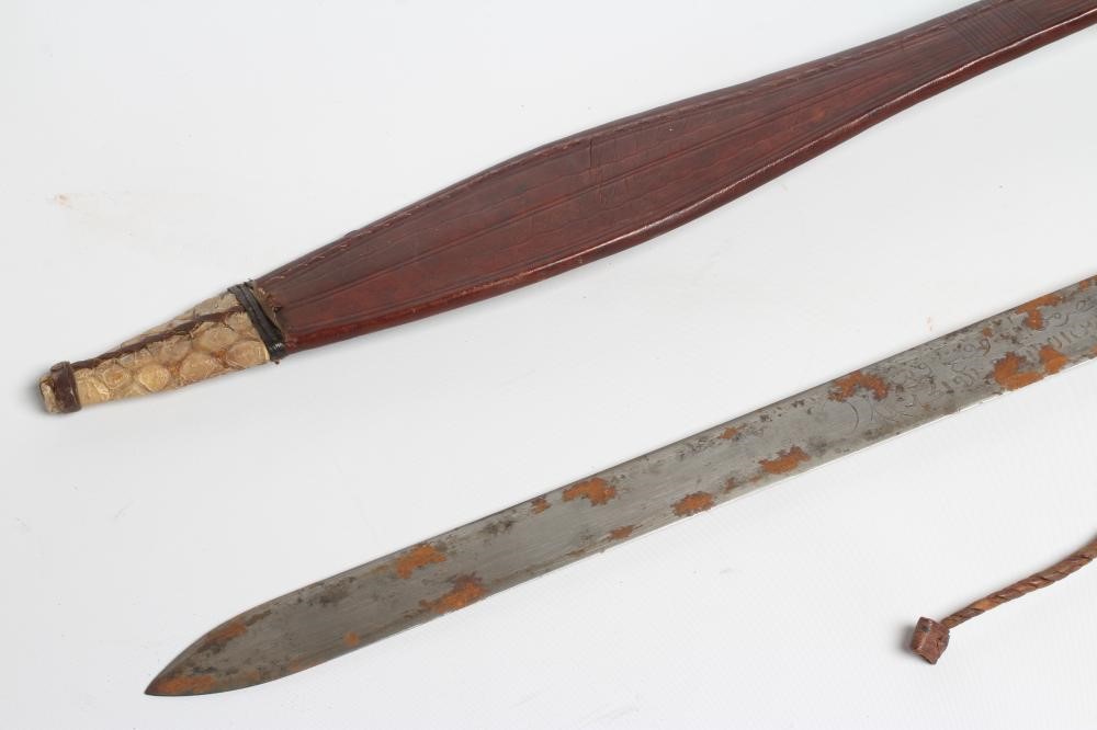 A SUDANESE KASKARA SWORD, the 34 1/2" blade etched with script and repeating designs, cruciform Image