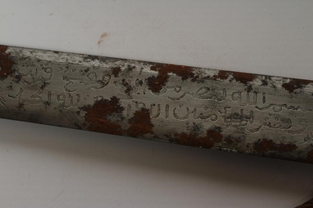 A SUDANESE KASKARA SWORD, the 34 1/2" blade etched with script and repeating designs, cruciform Image