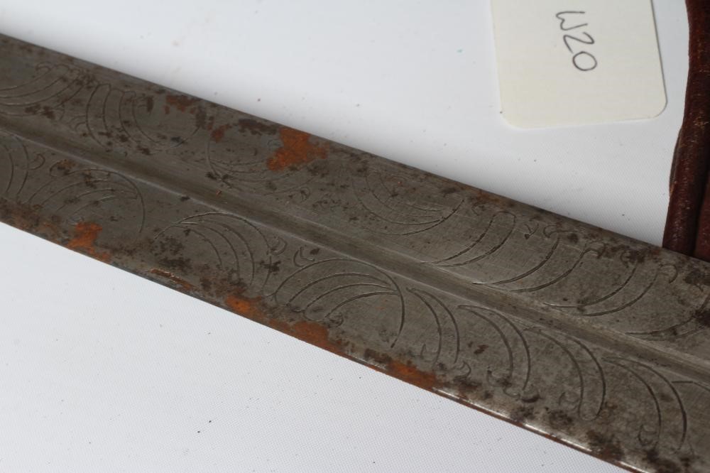 A SUDANESE KASKARA SWORD, the 34 1/2" blade etched with script and repeating designs, cruciform Image