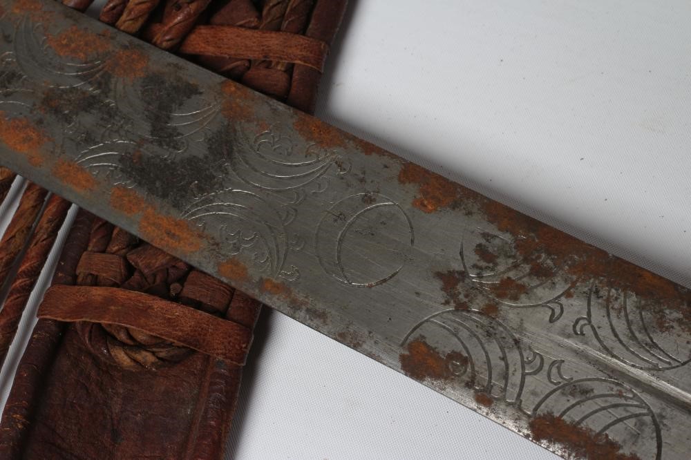 A SUDANESE KASKARA SWORD, the 34 1/2" blade etched with script and repeating designs, cruciform Image