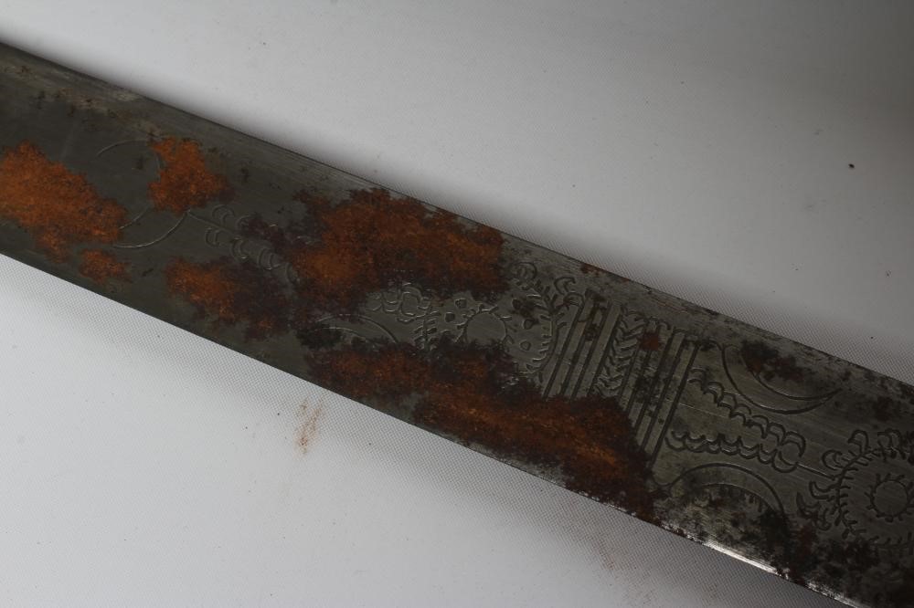 A SUDANESE KASKARA SWORD, the 34 1/2" blade etched with script and repeating designs, cruciform Image