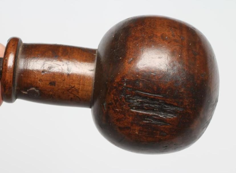 A BOATSWAIN'S KOSH, 19th century, with spherical head, flexible leather link and turned grip, Image