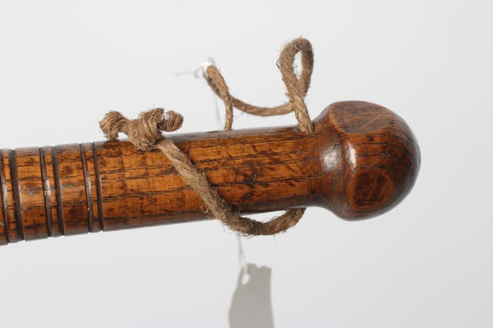 A BOATSWAIN'S KOSH, 19th century, with spherical head, flexible leather link and turned grip, Image