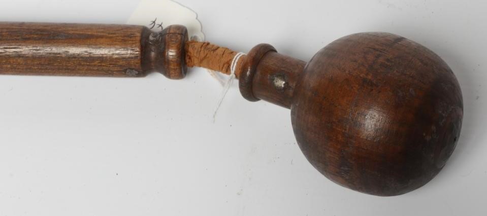 A BOATSWAIN'S KOSH, 19th century, with spherical head, flexible leather link and turned grip, Image