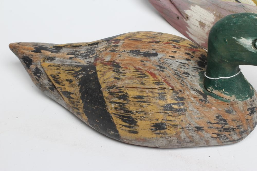 TWO DUCK DECOYS, early 20th century, possibly American, with painted exterior and flat base, largest Image