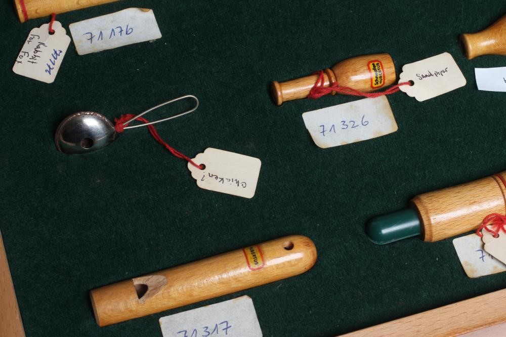 A RARE VINTAGE TRAVELLING SALESMAN'S CASE OF ANIMAL CALLS AND HUNTING WHISTLES Image
