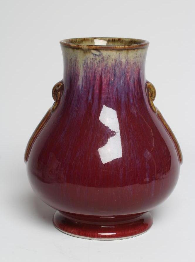 A CHINESE SANG DE BOEUF GLAZED VASE of baluster form with two fixed ring and tassel 'handles' Image