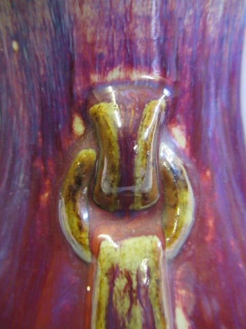 A CHINESE SANG DE BOEUF GLAZED VASE of baluster form with two fixed ring and tassel 'handles' Image
