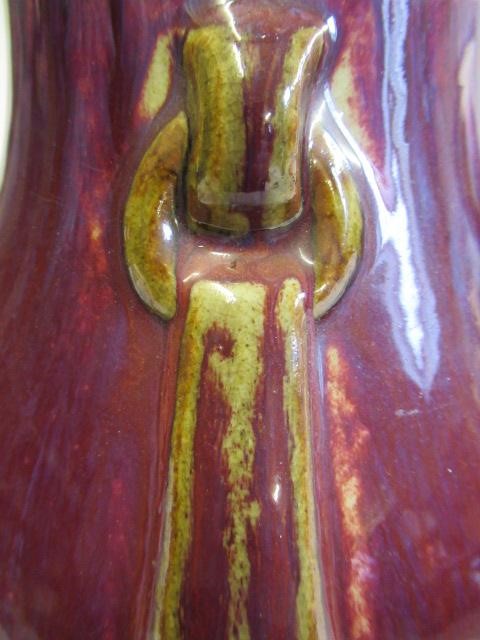 A CHINESE SANG DE BOEUF GLAZED VASE of baluster form with two fixed ring and tassel 'handles' Image
