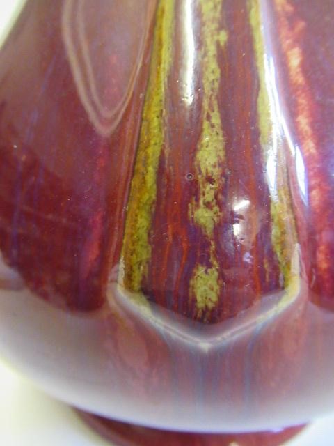 A CHINESE SANG DE BOEUF GLAZED VASE of baluster form with two fixed ring and tassel 'handles' Image