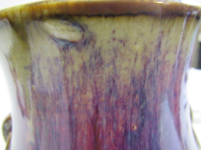 A CHINESE SANG DE BOEUF GLAZED VASE of baluster form with two fixed ring and tassel 'handles' Image