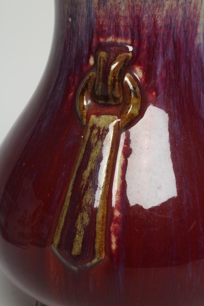 A CHINESE SANG DE BOEUF GLAZED VASE of baluster form with two fixed ring and tassel 'handles' Image