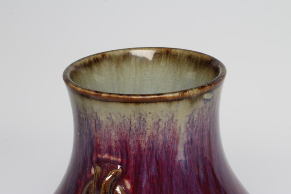A CHINESE SANG DE BOEUF GLAZED VASE of baluster form with two fixed ring and tassel 'handles' Image